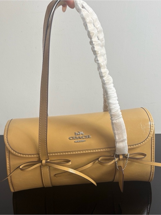 Coach Handbags - Coach Mustard Pebbled Leather Barrel Bag with Bow Accents